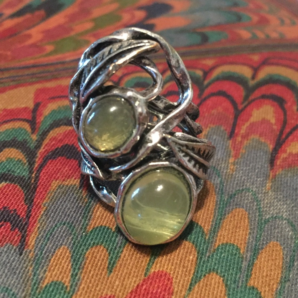 Silvery ring with leaf detail and stones